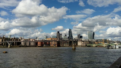 City by river against sky