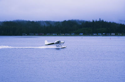 Boat on lake against clear sky