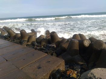 Rocks on beach against sky