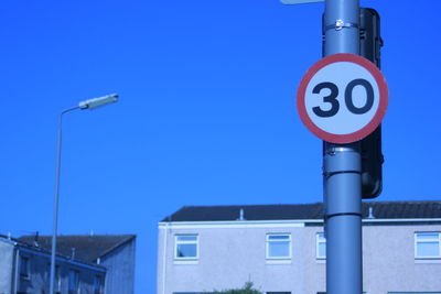 Low angle view of street light against clear blue sky