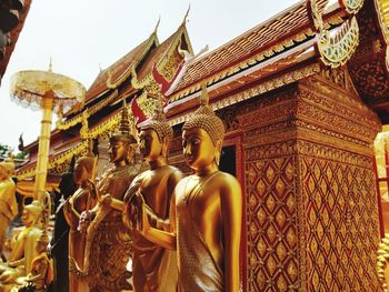 Low angle view of statue against temple building