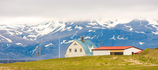 Airport buildings and lighting poles on the edge of an icelandic island.