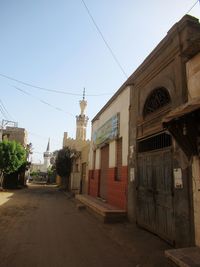 Street amidst buildings against sky in city