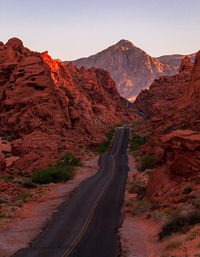 Road amidst rocks against clear sky