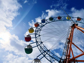 Low angle view of ferris wheel against sky