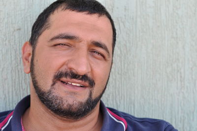 Portrait of smiling man against wall