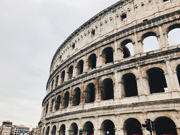 Low angle view of coliseum against sky