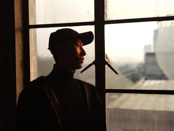 Man standing by window