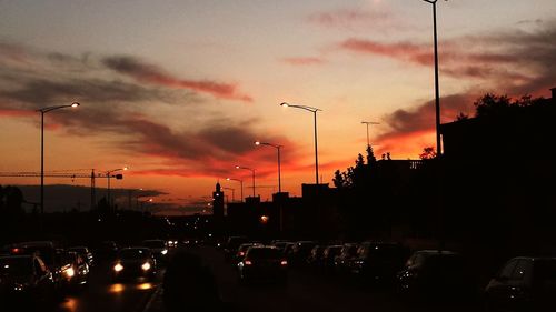 Traffic on road at sunset