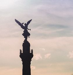 Low angle view of statue against sky during sunset