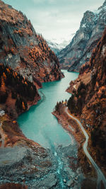 Scenic view of lake by mountains against sky