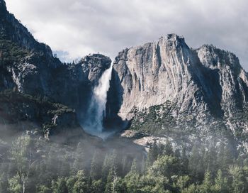 Scenic view of waterfall against sky