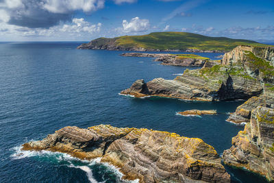 Kerry cliffs and turquoise water of atlantic ocean illuminated by sunlight, ireland