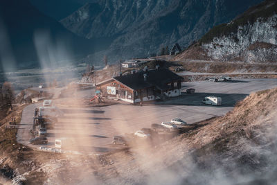 Panoramic shot of road by buildings against mountain