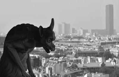 View of statue against buildings in city