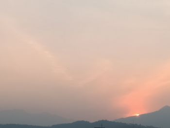 Scenic view of silhouette mountains against sky at sunset