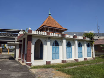 Exterior of temple against clear blue sky