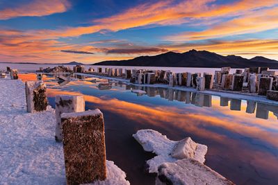 Scenic view of salt lake at salar de uyuni against sky during sunset