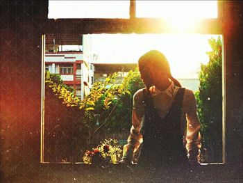 Woman standing by railing