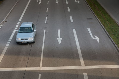 High angle view of arrow sign on road in city