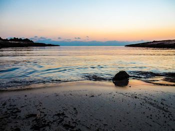 Scenic view of beach at sunset