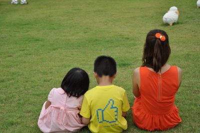 Rear view of people on grass