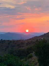 Scenic view of mountains against sky during sunset