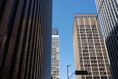 Low angle view of skyscrapers against clear sky