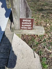 High angle view of information sign on footpath