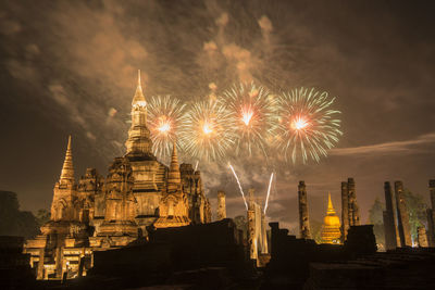 Firework display in city at night