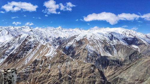 Aerial view of snowcapped mountains against sky