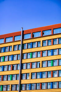 Beautiful view of the front facade of a colorful building with a red roof