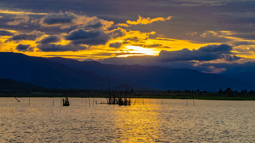 Scenic view of silhouette mountains against sky during sunset