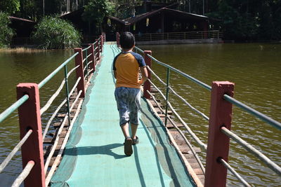 Rear view of man on footbridge