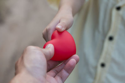 Close-up of woman holding red hand