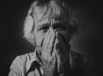 Close-up of sad woman against wall