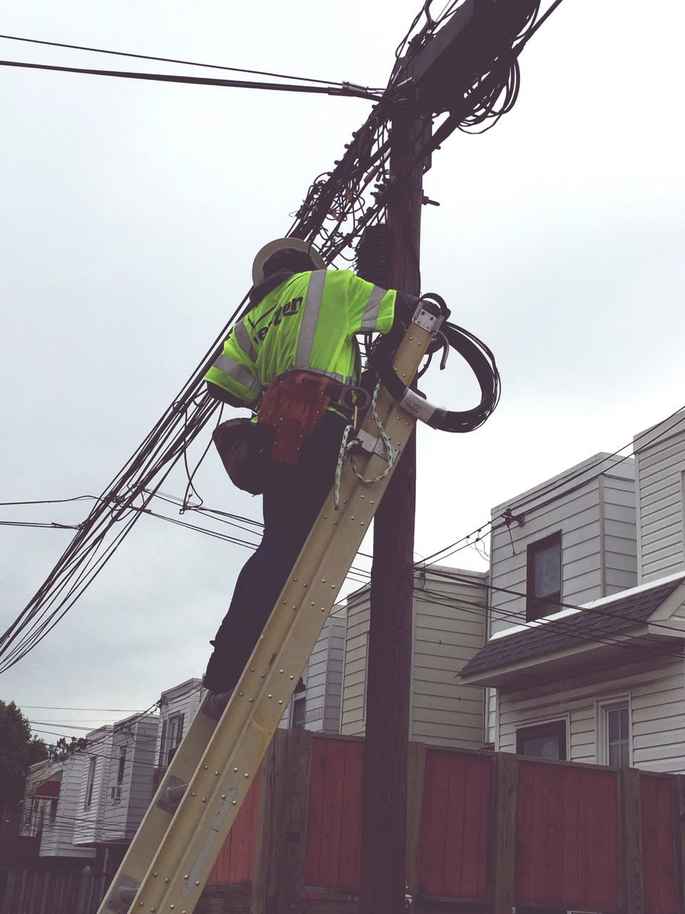 low angle view, built structure, architecture, building exterior, transportation, cable, mode of transport, sky, bicycle, clear sky, power line, land vehicle, outdoors, day, connection, no people, sunlight, electricity pylon, pole, electricity