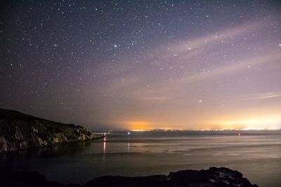 Scenic view of sea against sky at night