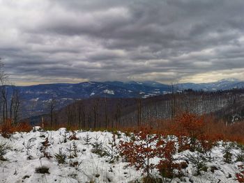Scenic view of snow covered mountains against sky