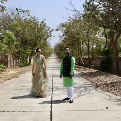 Rear view of man walking on footpath