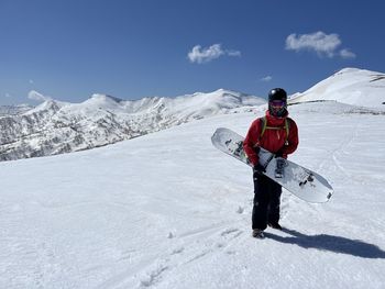 Low angle view of man skiing on snowcapped mountain