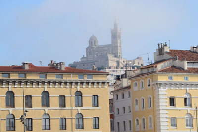 Low angle view of built structures against clear sky