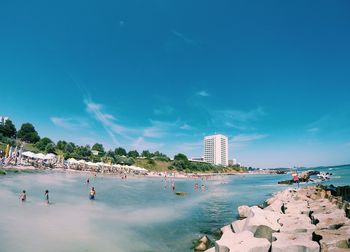 Scenic view of beach against blue sky