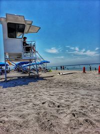 Lifeguard hut on beach against sky