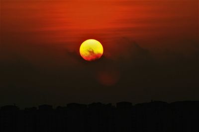 Scenic view of silhouette moon against sky at sunset
