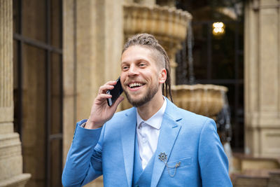 Portrait of young man using mobile phone