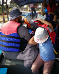 Rear view of two people in bus