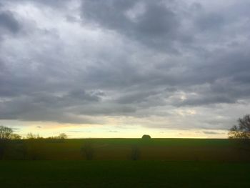 Scenic view of field against sky during sunset