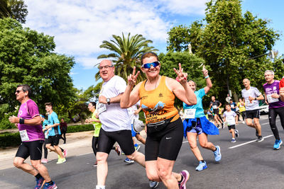 Group of people running against plants