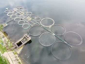 High angle view of wet metal over lake against sky